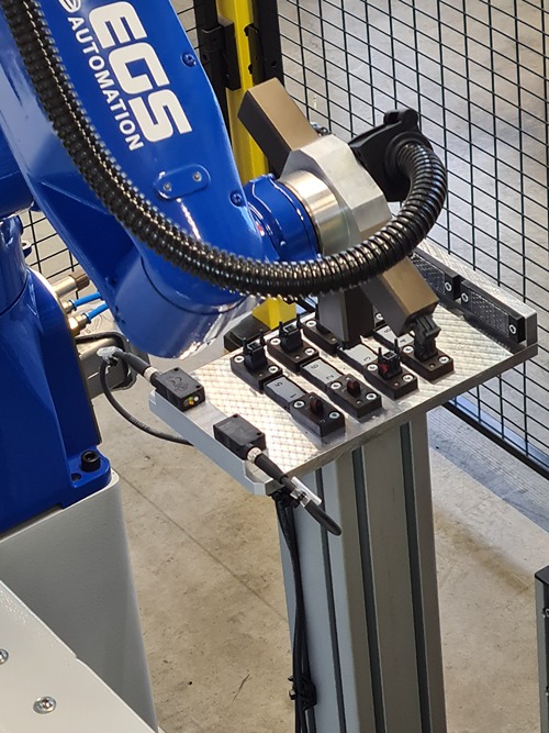 Industrieroboter mit Greifer bei automatisierter Montage- und Handhabungsanwendung in der Fabrikautomation, präzise Werkstückpositionierung für industrielle Produktionsprozesse.